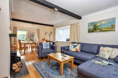 a living room with a blue couch and a table at Finest Retreats - The Duck House in Braithwaite