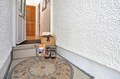 a pair of shoes sitting on a rug in front of a door at Finest Retreats - The Duck House in Braithwaite