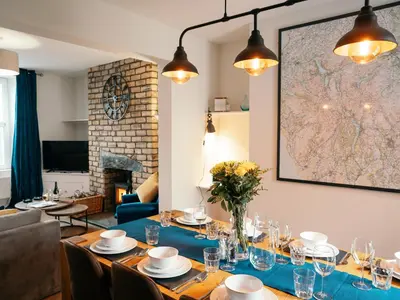 a dining room with a table and a fireplace at The Deekabout in Keswick