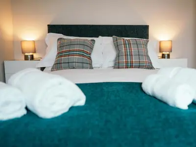 a bedroom with a bed with white pillows at The Deekabout in Keswick