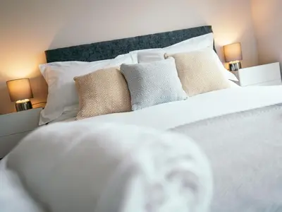 a bedroom with a white bed with pillows at The Deekabout in Keswick