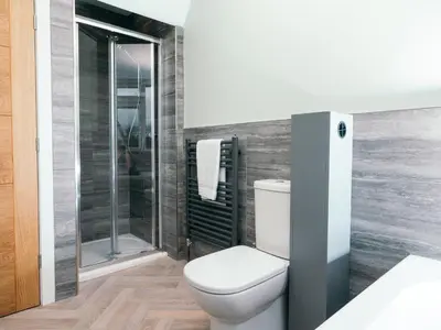 a bathroom with a toilet and a shower at The Deekabout in Keswick