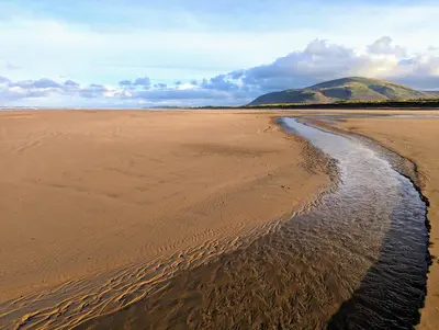 a view of a beach with a mountain in the background at Wayside Cottage 1637 in Millom