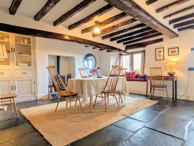 a dining room with a table and chairs at Wayside Cottage 1637 in Millom