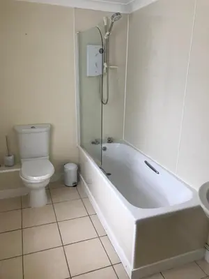 a bathroom with a tub and a toilet and a sink at The Maxwell Arms Hotel in Dalbeattie
