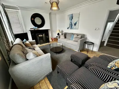 a living room with two couches and a fireplace at 3 The Townhouse in Keswick