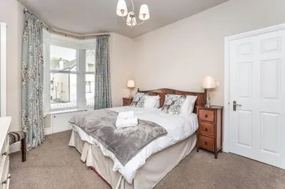 a bedroom with a bed and a window at 9 The Townhouse in Keswick