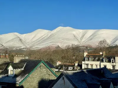 a group of houses in front of snowy mountains at 9 The Townhouse in Keswick