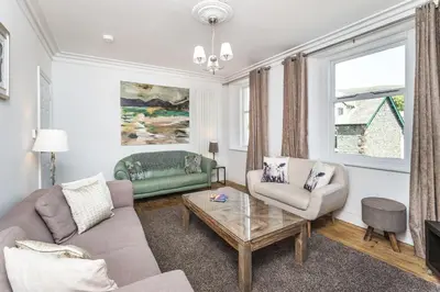a living room with a couch and a table at 7 The Townhouse in Keswick