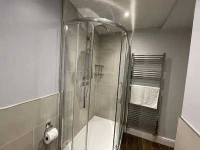 a shower with a glass door in a bathroom at Park View in Keswick