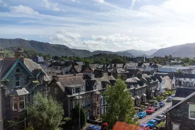 a town with houses and cars on a street at Skiddaw Skies in Keswick