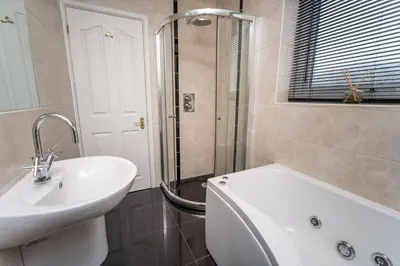 a white bathroom with a sink and a shower at Appletree in Portinscale