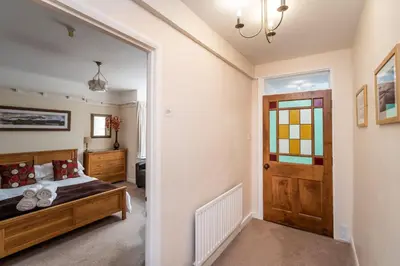a bedroom with a bed and a window and a door at The Ridgeway in Keswick