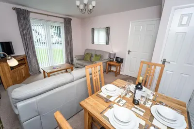 a living room with a couch and a table at Elm Cottage in Keswick