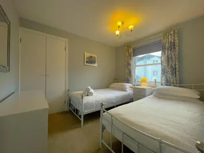 a bedroom with two beds and a window at Coledale in Keswick
