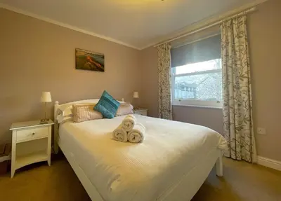 a bedroom with a bed with two towels on it at Coledale in Keswick