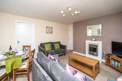 a living room with a couch and a table at Coledale in Keswick