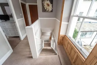 a winding staircase in a home with a window at Bridge Cottage in Keswick