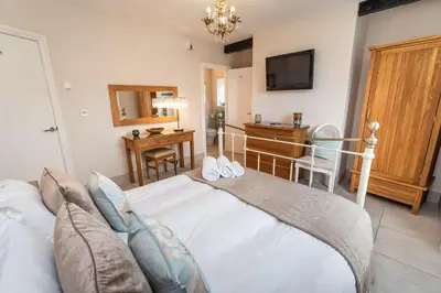 a bedroom with a bed and a television in it at Bridge House in Keswick