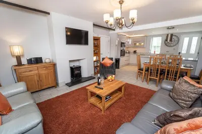 a living room with a couch and a table at Bridge House Apartment 1 in Keswick