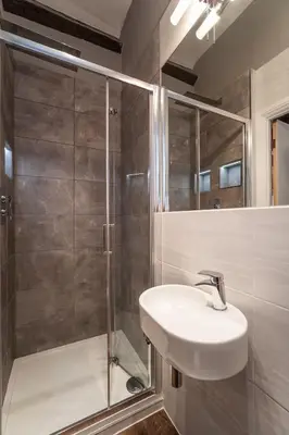 a bathroom with a sink and a shower at Bridge House Apartment 3 in Keswick