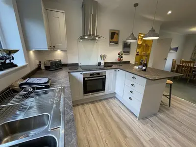a kitchen with a sink and a stove top oven at Causey View in Braithwaite