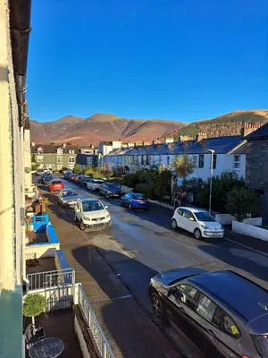 a city street with cars parked in a parking lot at Byways in Keswick