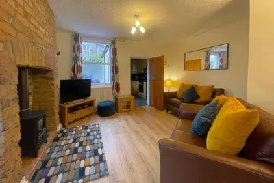 a living room with a couch and a fireplace at Byways in Keswick