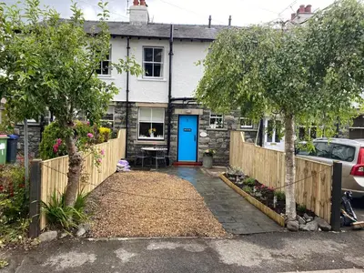 a house with a blue door and a fence at Birchgate in Keswick