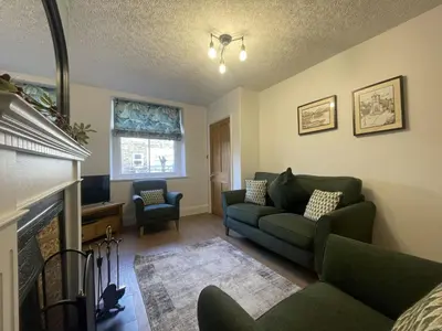 a living room with a couch and a fireplace at Birchgate in Keswick