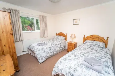 a bedroom with two beds and a window at Blencathra in Keswick