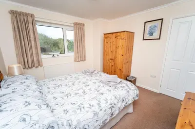 a bedroom with a bed and a window at Blencathra in Keswick