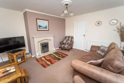 a living room with a couch and a fireplace at Blencathra in Keswick