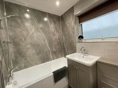 a bathroom with a tub and a sink and a shower at Blencathra in Keswick