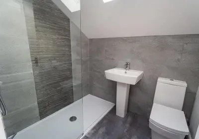 a bathroom with a sink and a toilet and a shower at Alison's View in Keswick