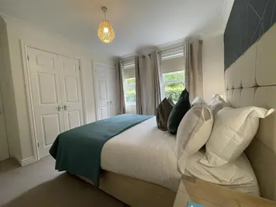 a bedroom with a large bed and a window at Maiden Moor in Keswick