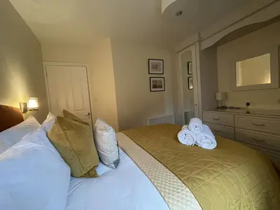 a bedroom with a bed with towels on it at Lake View Cottage in Braithwaite