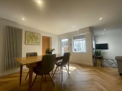 a dining room with a wooden table and chairs at Daisy Cottage in Keswick