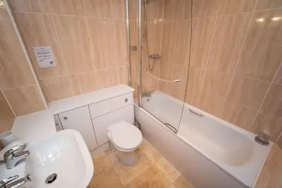 a bathroom with a sink and a toilet and a shower at Greta Bank in Keswick