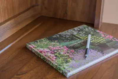a book sitting on the floor with a pen on it at Crosthwaite Gardens in Keswick