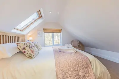 a bedroom with a bed with two towels on it at Crosthwaite Gardens in Keswick