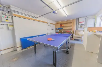 a room with a ping pong table in it at Crosthwaite Gardens in Keswick