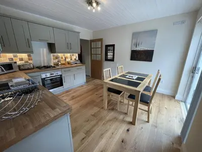 a kitchen with a table and chairs in a room at Rock Lynn in Braithwaite
