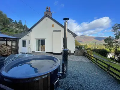 a bath tub in front of a house at Rock Lynn in Braithwaite
