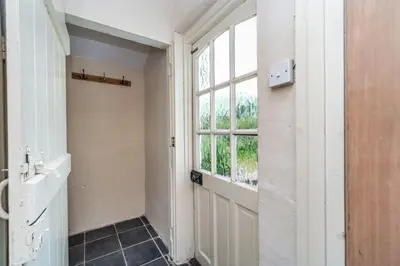 an empty room with a door and a window at Rose Bank Cottage in Braithwaite
