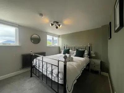 a bedroom with a bed and a window at Mountain View in Keswick