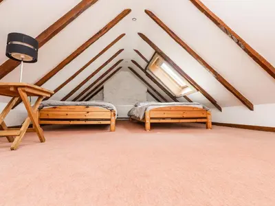 a room with two beds in a attic at 2 Burnside Place in Kirkcudbright