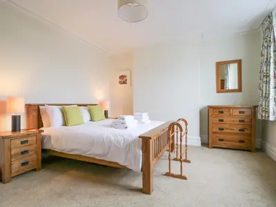 a bedroom with a large bed and a dresser at Shields in Keswick