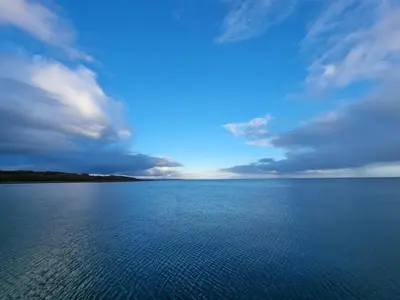 a large body of water under a cloudy sky at Harbourside in Garlieston