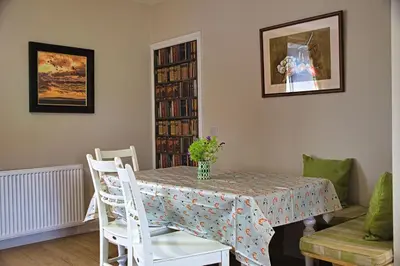 a dining room with a table and chairs at Beachcombers in Dumfries